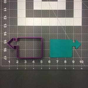 May include: Two cookie cutters, one purple and one green, shaped like rectangles with arrows on the sides. The purple cutter has an arrow pointing to the left, and the green cutter has an arrow pointing to the right.