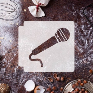 May include: A white stencil of a microphone on a brown surface covered in flour. The stencil is on a white background.