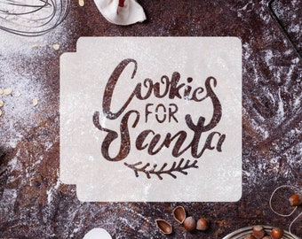 May include: A white stencil with the text "Cookies for Santa" in black script lettering. The stencil is on a brown surface with flour scattered around it. There are also other baking supplies, such as a whisk, a bag of flour, and a bowl of nuts.