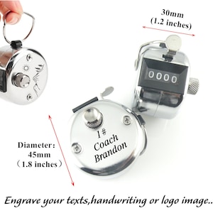 May include: Silver-toned hand-held counter with a black digital display. The counter is 1.8 inches in diameter and has a ring on top. The counter can be engraved with text, handwriting, or a logo. The text "1# Coach Brandon" is engraved on the counter.