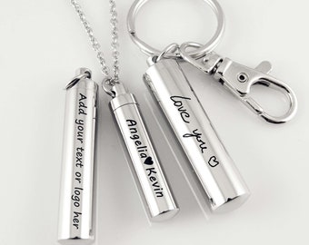 May include: Three silver metal cremation urns with engraved text. The urns are attached to chains and a key ring. The text on the urns reads "Add your text or logo here", "Love you", and "Angelia Kevin".