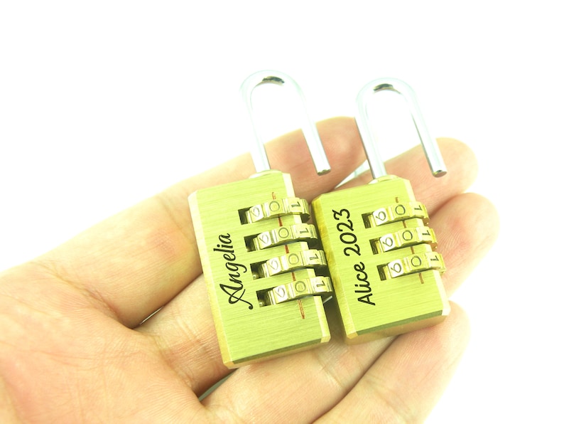 May include: Two gold combination locks with personalised engravings. The lock on the left says "Angelia" and the lock on the right says "Alice 2023".