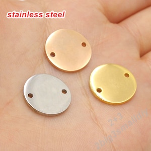 May include: Three round metal discs with two holes each. The discs are silver, gold, and rose gold.
