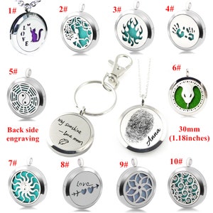 May include: Ten silver-toned aromatherapy diffusers with different designs. The diffusers are round and have a small opening on the top. Some of the designs include a cat, a tree, flames, hands, a yin-yang symbol, a snake, a sun, an arrow with hearts, a flower, and a swirl. The diffusers are 30mm (1.18 inches) in diameter.