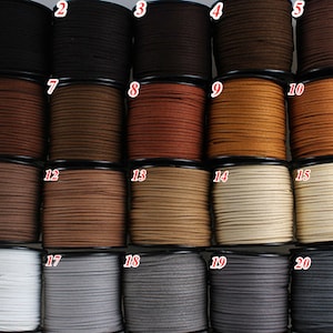May include: Twenty spools of suede cord in various colors, including black, brown, beige, and gray. Each spool is labeled with a number from 1 to 20.