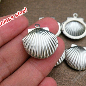 May include: Five silver-toned seashell-shaped locket pendants with a hinged opening. The lockets are made of stainless steel.