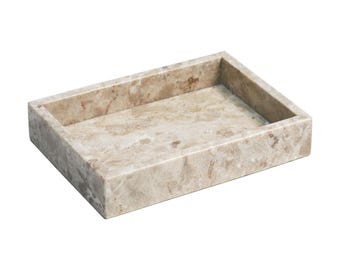 May include: A rectangular beige marble tray with a smooth surface. The tray is perfect for holding jewelry, keys, or other small items.