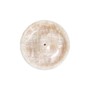 May include: A round, white onyx soap dish with a small drainage hole in the centre.