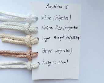 Rug swatches - white, ivory, off-white, beige. Cord examples