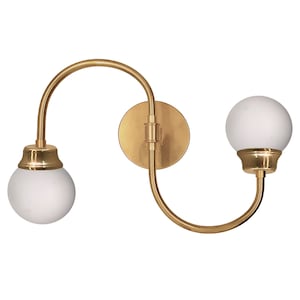 Brass vanity sconce. Twin milk white globe shade.