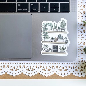 May include: A sticker of a shelf with potted plants and the text "Life is beautiful".