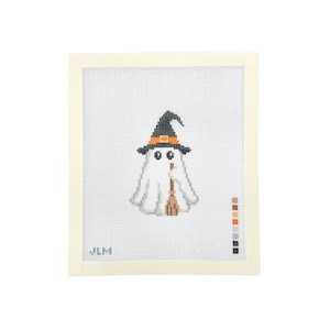 May include: A needlepoint canvas featuring a white ghost wearing a black witch hat with an orange band, holding a brown broomstick. The design is centered on a white grid with a color palette key on the right side and the letters JLM in the corner.