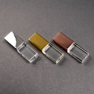 May include: Three crystal USB flash drives with different colored metal caps: silver, gold, and rose gold.
