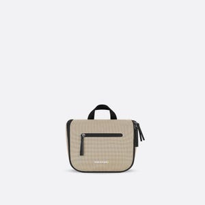 May include: A beige travel bag with a black handle and zipper pulls. The bag has a rectangular shape with rounded corners and the brand name "SHERPANI" printed on the front. The bag is approximately 8 inches wide.