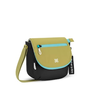 May include: A black and olive green crossbody bag with a light blue zipper and trim. The bag has a long, adjustable strap and a white logo on the front. The brand name "sherpani" is on a black tag.