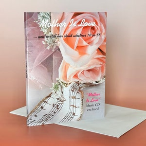 May include: A card with a pink and white floral design and the text "Mother Is Love... you're still her child whether 10 or 55". The card also includes the text "Mother Is Love" and "Music CD enclosed".