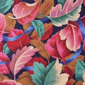 May include: A fabric with a repeating pattern of colorful leaves in shades of red, pink, green, brown, and blue. The leaves are arranged in a random pattern on a dark blue background.