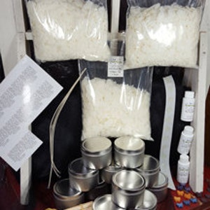 May include: Candle making kit with white wax flakes, metal tins, wicks, and essential oils.
