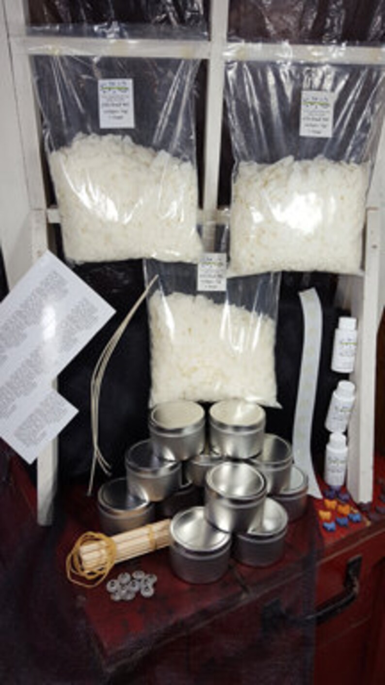 May include: Candle making kit with white wax flakes, metal tins, wicks, and essential oils.