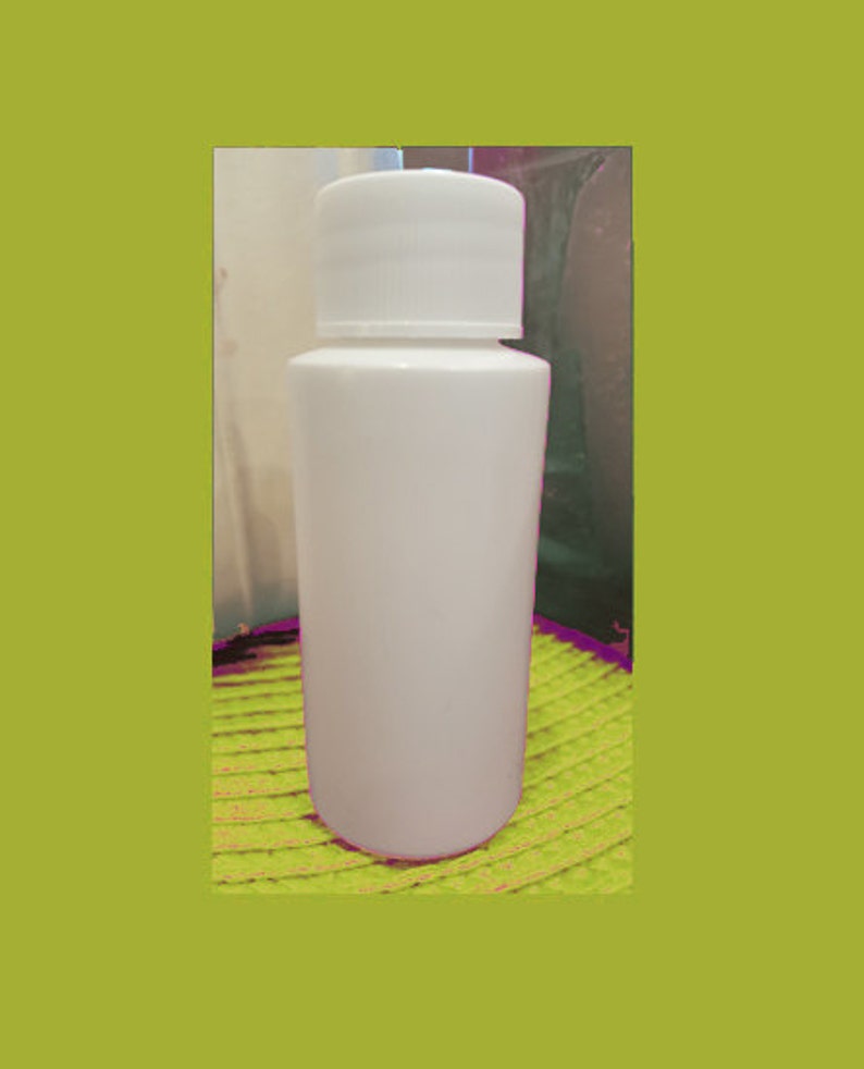 May include: White plastic bottle with a white screw-on lid. The bottle is sitting on a green and yellow surface.