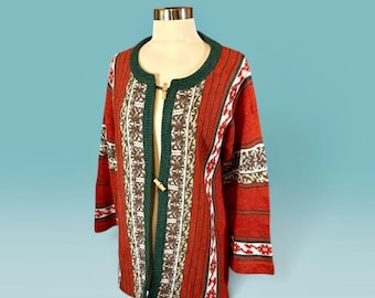 May include: A long-sleeved knit cardigan in a vibrant red hue, featuring a dark green ribbed collar and trim. The garment is adorned with vertical panels of intricate brown, white, and red geometric patterns and includes two wooden toggle closures.