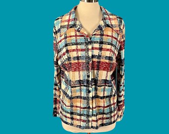 May include: A long-sleeved button-down shirt with a plaid pattern in shades of red, blue, beige, and black.