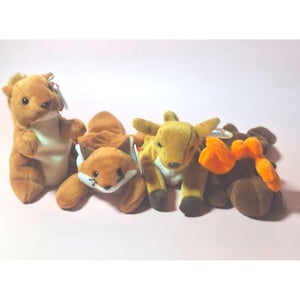May include: Four plush beanie baby toys: a brown squirrel, a brown fox, a brown and tan deer, and a brown moose with orange antlers.