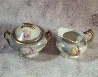 Antieke Erdmann Schlegelmilch suikerpot en creamer set met roze bloemdessin