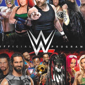 May include: A promotional poster for a WWE event featuring multiple wrestlers. The poster has the WWE logo in the center, with the words "OFFICIAL PROGRAM" at the top and bottom. The wrestlers are in various poses, with a mix of male and female wrestlers.