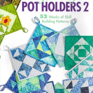 May include: A collection of colorful, quilted pot holders in various geometric patterns. The image features a book titled "Year of Pot Holders 2" by Carolyn S. Vagts, with the Annie's Quilting logo. The pot holders are in shades of blue, green, and white.