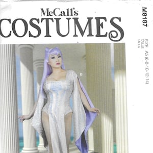 May include: McCall's M8187 costume pattern. The image shows a woman in a white and silver costume with long sleeves and a cape. The pattern includes body measurements in inches and sizes 6-14.
