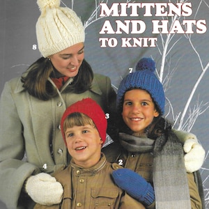 May include: Image of a vintage knitting pattern cover featuring three people wearing knitted hats and mittens. The text "MITTENS AND HATS TO KNIT" is displayed prominently. The design is by Marion Graham.