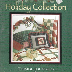 May include: A book cover for the "Holiday Collection" by Thimbleberries. The cover features a framed image of a bed with decorative pillows, a quilt, and a wrapped gift. The background is green with a repeating leaf pattern.