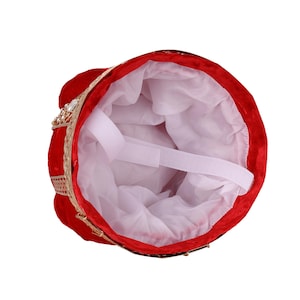 May include: Red velvet crown hat with gold accents and rhinestone embellishments. The interior is lined with white fabric and features an adjustable strap.  This regal headwear is perfect for costume parties, theatrical productions, or any occasion requiring a touch of royal flair.