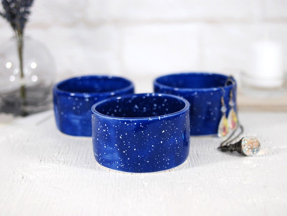 A hand-thrown ceramic ring dish with that satisfying irregular blue glaze you can't get from any factory — real pottery, real maker energy.