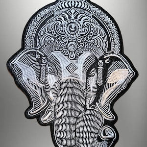 May include: Embroidered patch featuring a detailed elephant design in black and white. The elephant has intricate patterns and a decorative headpiece. The patch is likely for clothing or accessories.