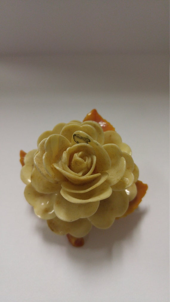 Vintage celluloid rose brooch.