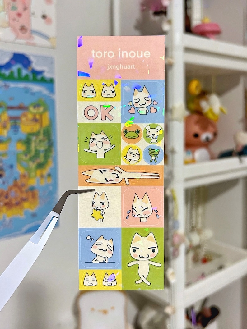 May include: A set of colourful stickers featuring a cartoon cat with different expressions. The stickers are arranged in a grid pattern and include the text "toro inoue" and "jxnghuart".
