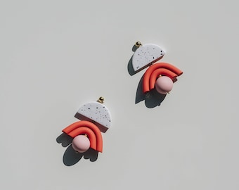 Terracotta and pastel pink speckled arch shaped polymer clay statement earrings. Modern and minimal every day clay jewelry.