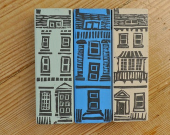 Trio of handprinted little wooden houses