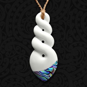 May include: White ceramic pendant with a twisted rope design and a blue abalone shell inlay. The pendant is attached to a brown cord.