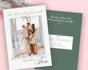 May include: A Christmas card with a family photo inside a white frame with vertical stripes. The card has the text "For God so loved the world that he gave his only begotten Son." The back of the card is green with text.