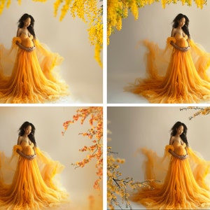 May include: A pregnant person in a yellow tulle gown stands in front of a white background with yellow flowers hanging above. The gown has a flowing skirt and a sweetheart neckline.