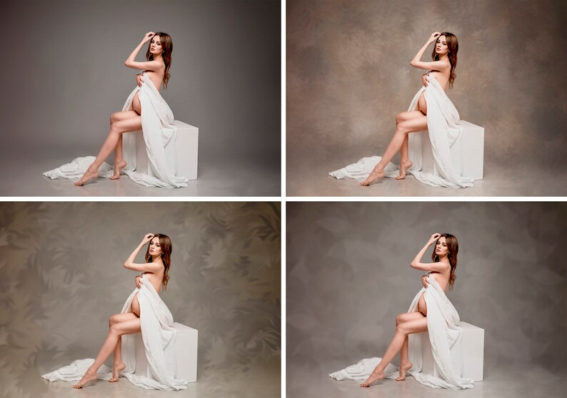 May include: A woman sits on a white cube, draped in a white sheet. The background is a neutral gray.