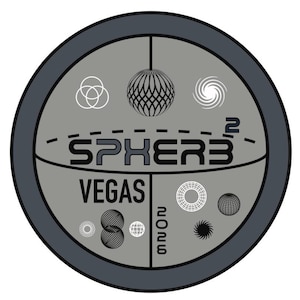 May include: Circular gray graphic with the text "SPHERE VEGAS 2023". The design includes various geometric shapes and a decorative sphere. The graphic is enclosed in a dark gray border.