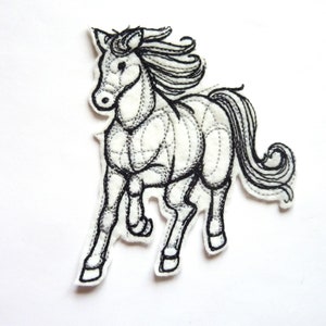 May include: A white felt horse applique with black embroidered detailing. The horse is shown in a running pose, with a flowing mane and tail. The applique is stitched with a dotted line pattern.