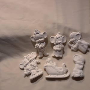 May include: Set of seven white ceramic Christmas ornaments featuring mice in various poses, including a mouse in a sleigh, a mouse holding a present, and a mouse ice skating.