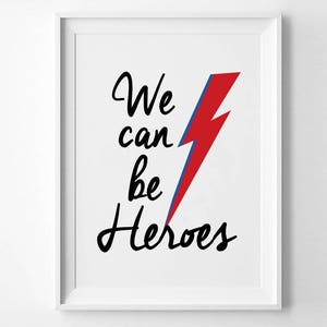 May include: White framed print with a red and blue lightning bolt and the text "We can be heroes" in black cursive.