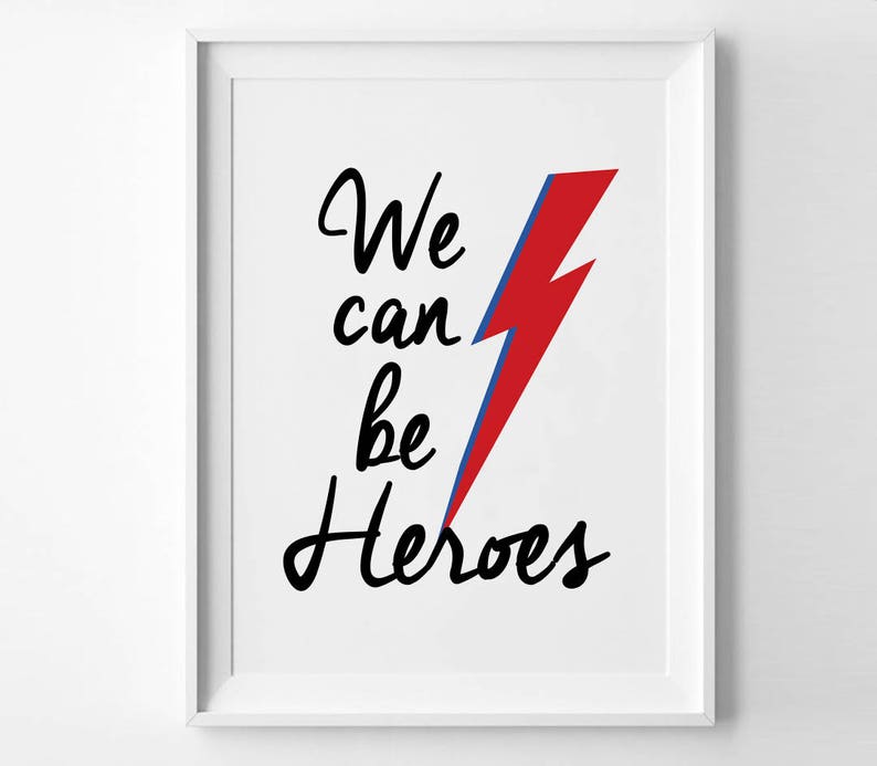 May include: White framed print with a red and blue lightning bolt and the text "We can be heroes" in black cursive.