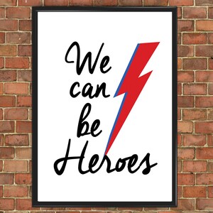 May include: A white framed print with a black and red lightning bolt graphic and the text "We can be Heroes".